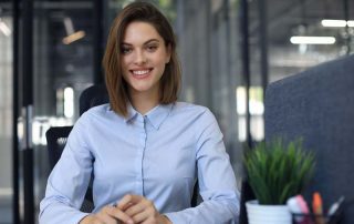 A businesswoman smiles in an office
