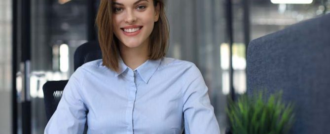 A businesswoman smiles in an office