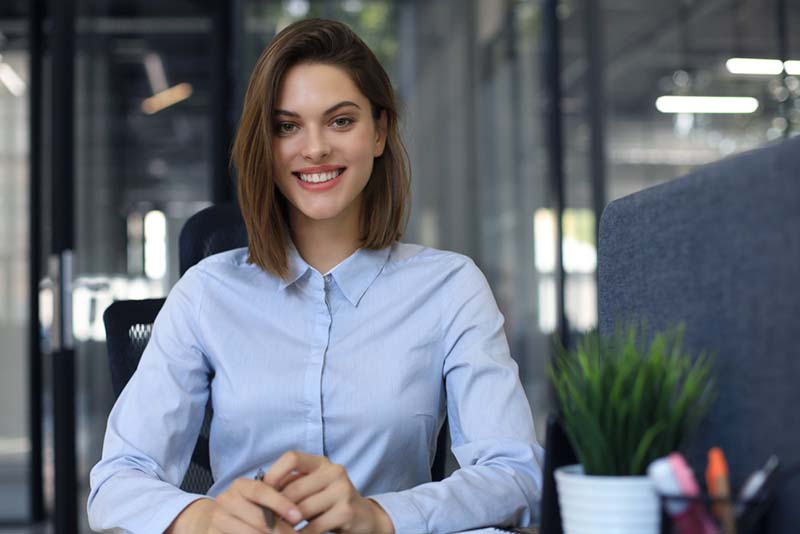 A businesswoman smiles in an office